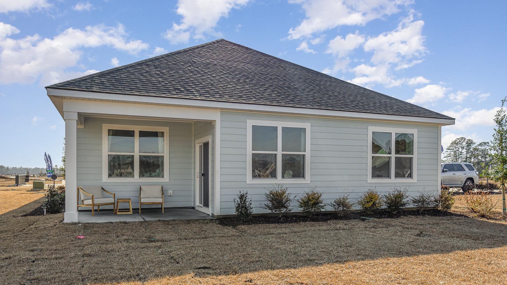 319 Ridley Street Longs, SC 29568 - Photo 27 of 30 Back of property featuring a patio and roof with shingles