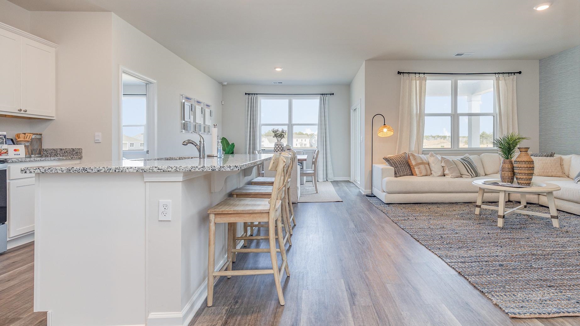 319 Ridley Street Longs, SC 29568 - Photo 29 of 30 Kitchen featuring open floor plan, dark wood-type flooring, a center island with sink, light stone counters, and recessed lighting