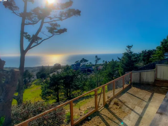 a view of balcony with wooden floor and fence