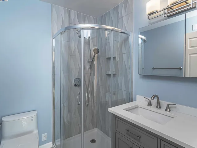 a bathroom with a sink a mirror and shower