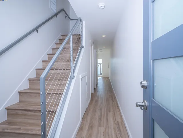 a view of entryway and gallery with wooden floor