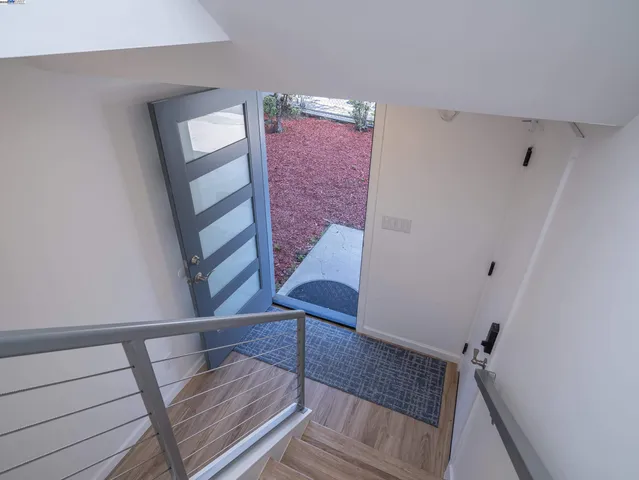 a view of staircase with white walls and railing