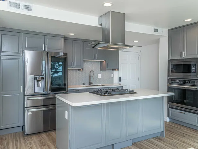 a kitchen with stainless steel appliances a refrigerator and a stove