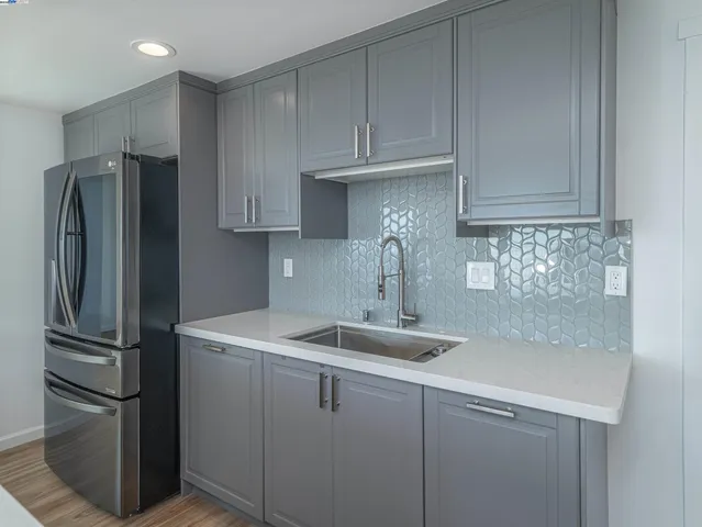 a kitchen with appliances and a refrigerator