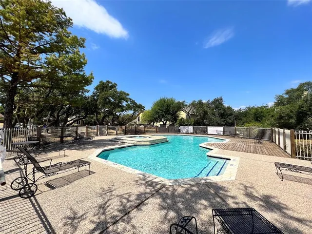 a view of a swimming pool with lounge chairs