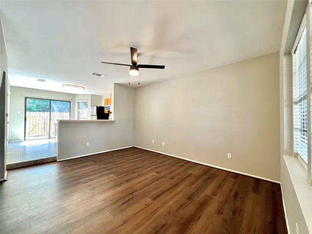 wooden floor in an empty room with a window