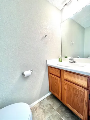 a bathroom with a sink mirror and toilet