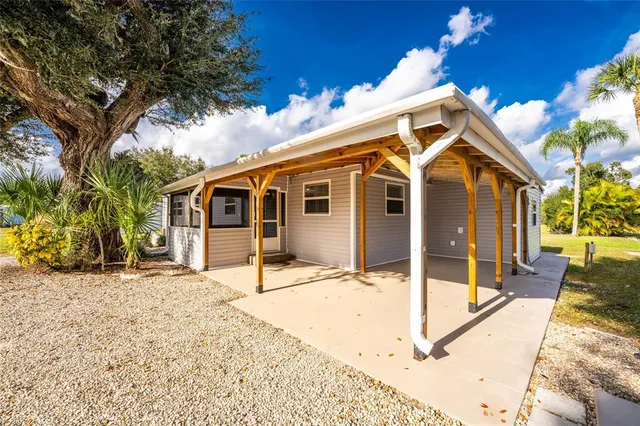 a view of empty room with wooden floor and windows