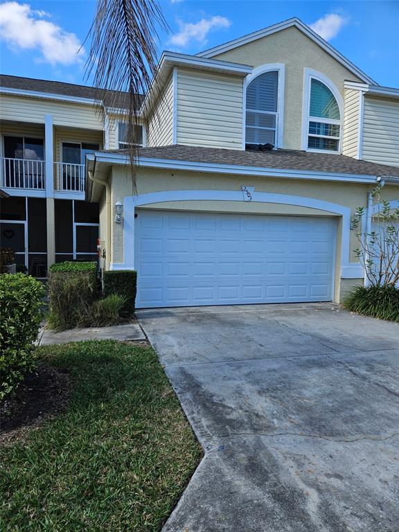 1050 Starkey Road, Unit 2503 Largo, FL 33771 - Photo 1 of 1 a front view of a house with a yard and garage