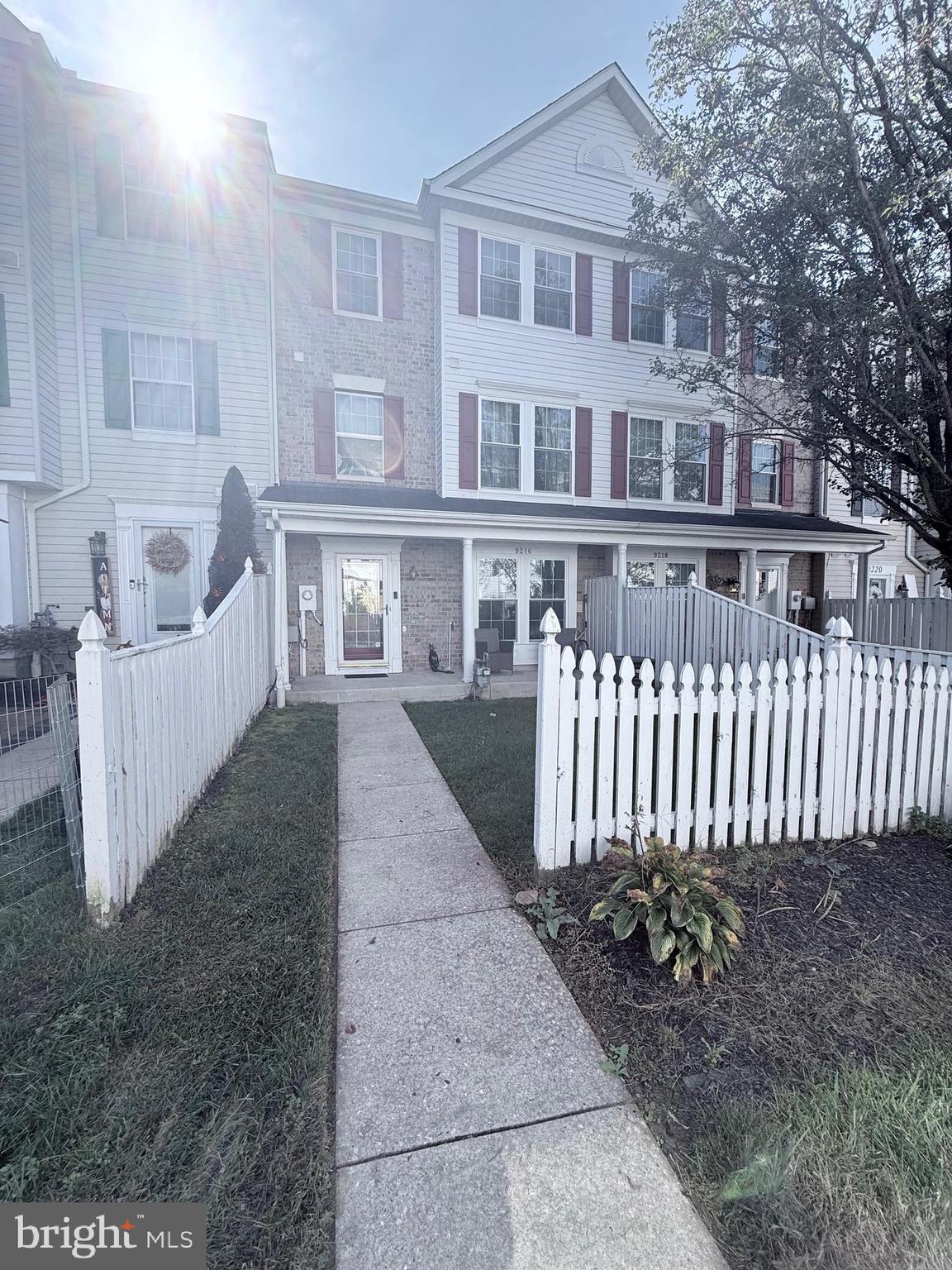 9216 Leigh Choice Court, Unit 10 Owings Mills, MD 21117 - Photo 1 of 32 a view of a house with a yard