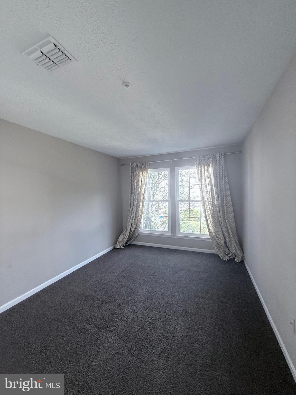 9216 Leigh Choice Court, Unit 10 Owings Mills, MD 21117 - Photo 14 of 32 an empty room with a empty space and windows