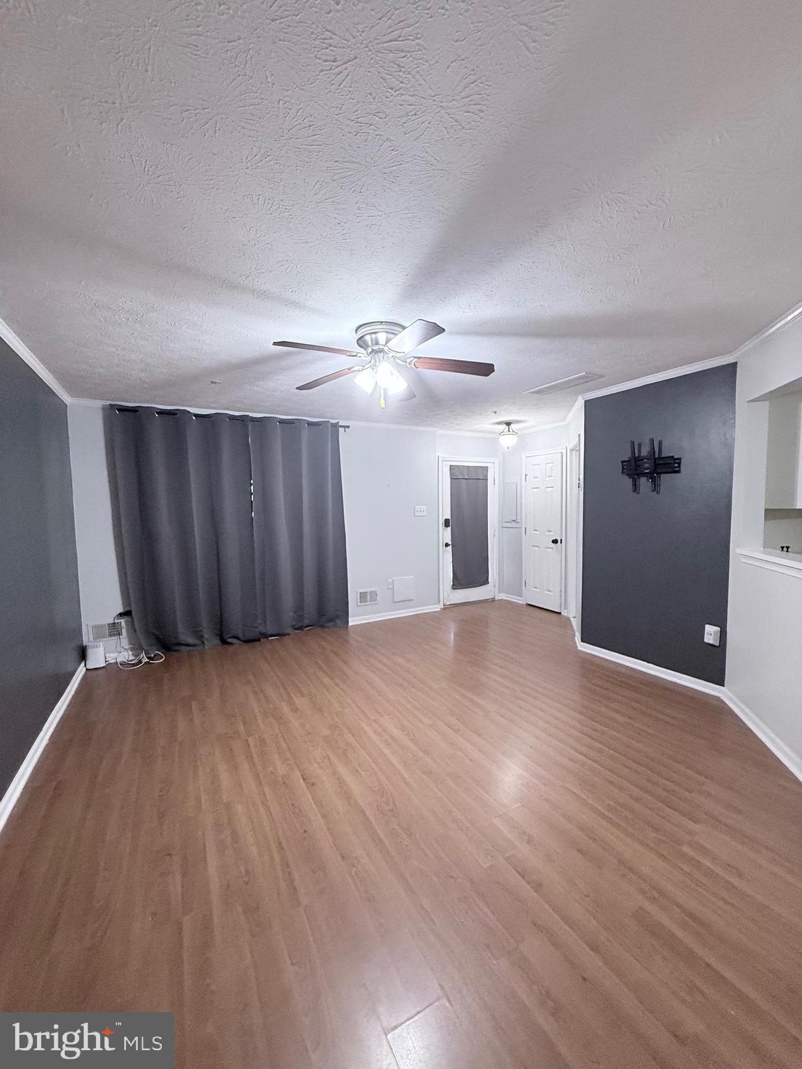 9216 Leigh Choice Court, Unit 10 Owings Mills, MD 21117 - Photo 5 of 32 a view of an empty room with wooden floor