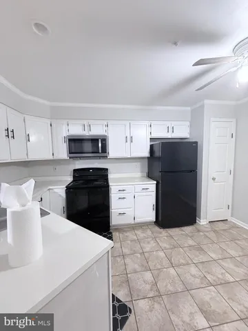 a kitchen with stainless steel appliances a refrigerator sink and cabinets