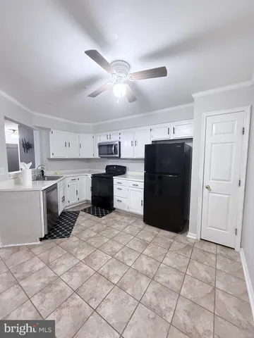 a kitchen with a cabinets and a stove top oven
