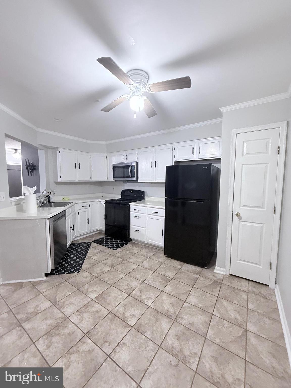 9216 Leigh Choice Court, Unit 10 Owings Mills, MD 21117 - Photo 7 of 32 a kitchen with a cabinets and a stove top oven