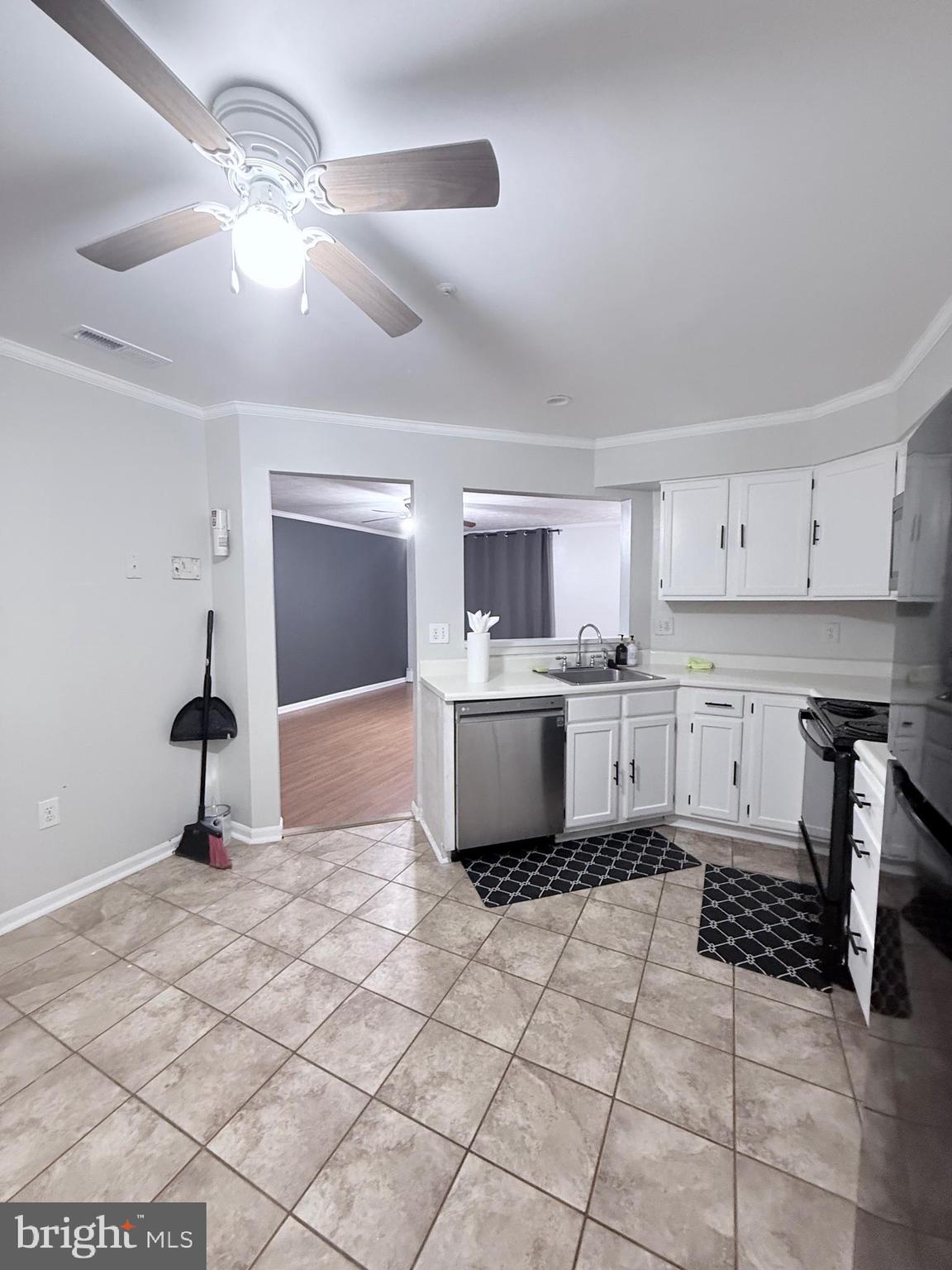 9216 Leigh Choice Court, Unit 10 Owings Mills, MD 21117 - Photo 8 of 32 a large white kitchen with a stove a sink and a refrigerator