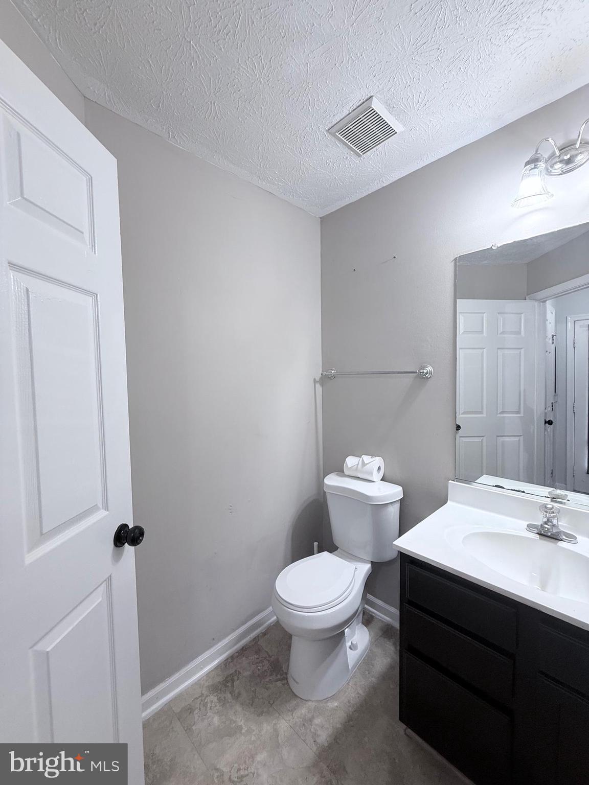 9216 Leigh Choice Court, Unit 10 Owings Mills, MD 21117 - Photo 10 of 32 a bathroom with a toilet a sink and a mirror