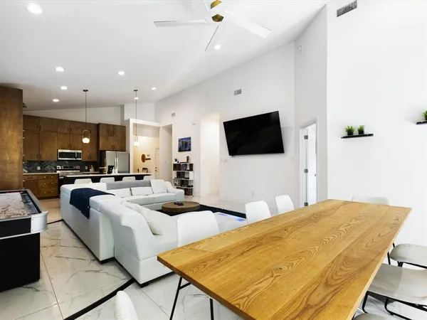 a kitchen with a sink a kitchen island a stove and a refrigerator