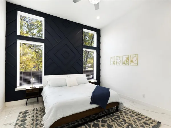 a bedroom with a large bed and a window