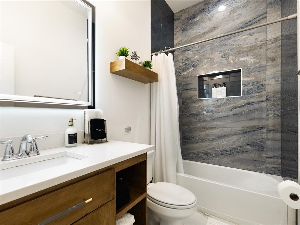 6221 Inca Drive Mabank, TX 75156 - Photo 19 of 35 a bathroom with a granite countertop sink a toilet and bathtub