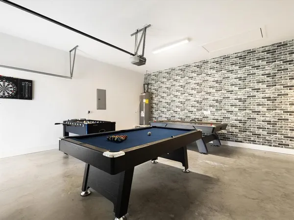 a living room with table chairs and a potted plant