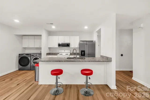 a kitchen with a sink a stove and refrigerator