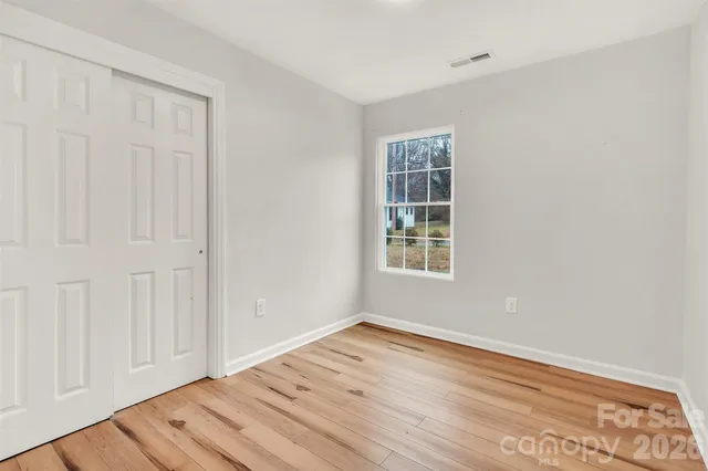 a view of a room with wooden floor