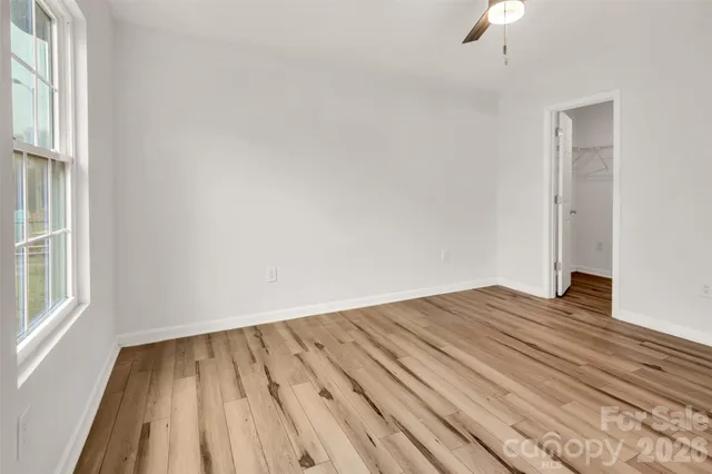 a bathroom with a granite countertop shower a mirror and a sink