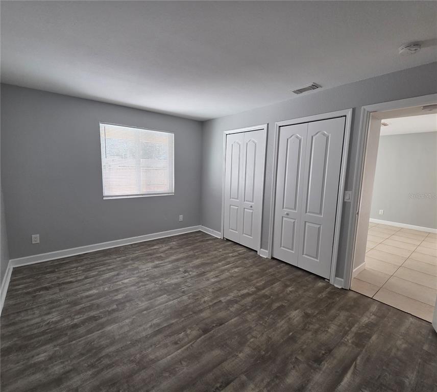 510 Golden Raintree Place, Unit 510 Brandon, FL 33510 - Photo 11 of 18 an empty room with wooden floor and windows