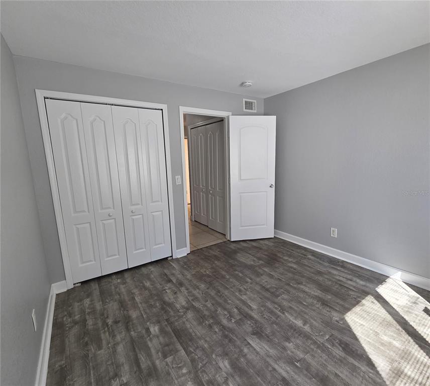 510 Golden Raintree Place, Unit 510 Brandon, FL 33510 - Photo 13 of 18 a view of empty room with wooden floor