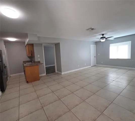 a view of a kitchen with a sink and a chandelier fan
