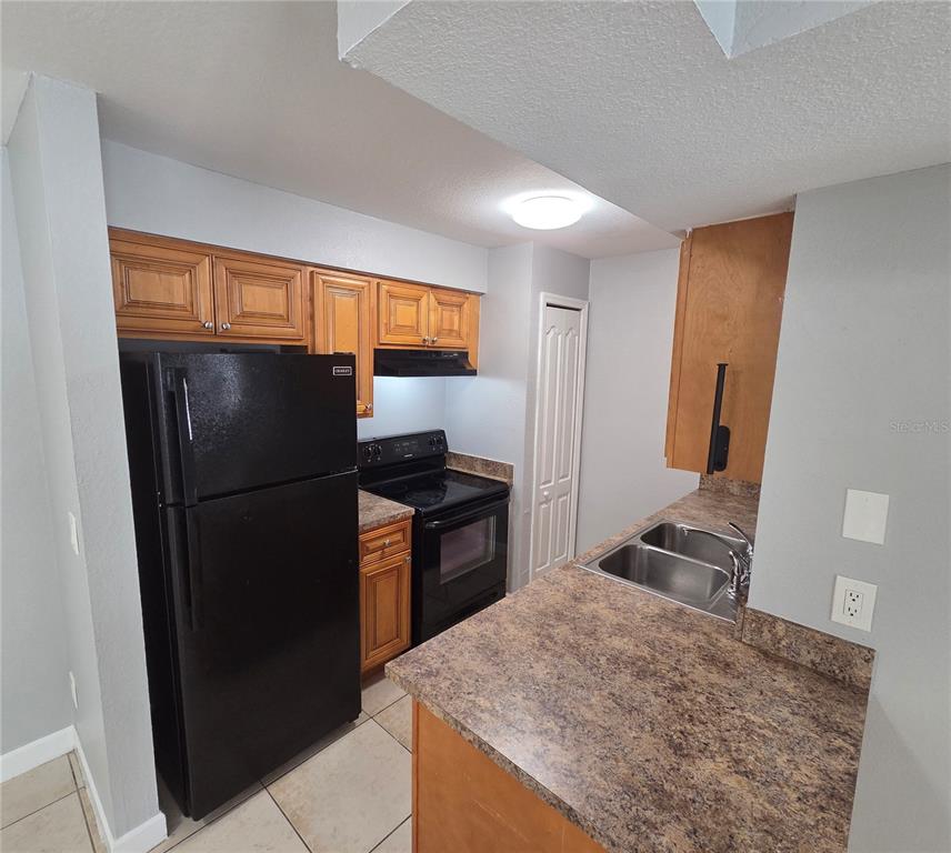 510 Golden Raintree Place, Unit 510 Brandon, FL 33510 - Photo 6 of 18 a kitchen with stainless steel appliances granite countertop a refrigerator and a sink