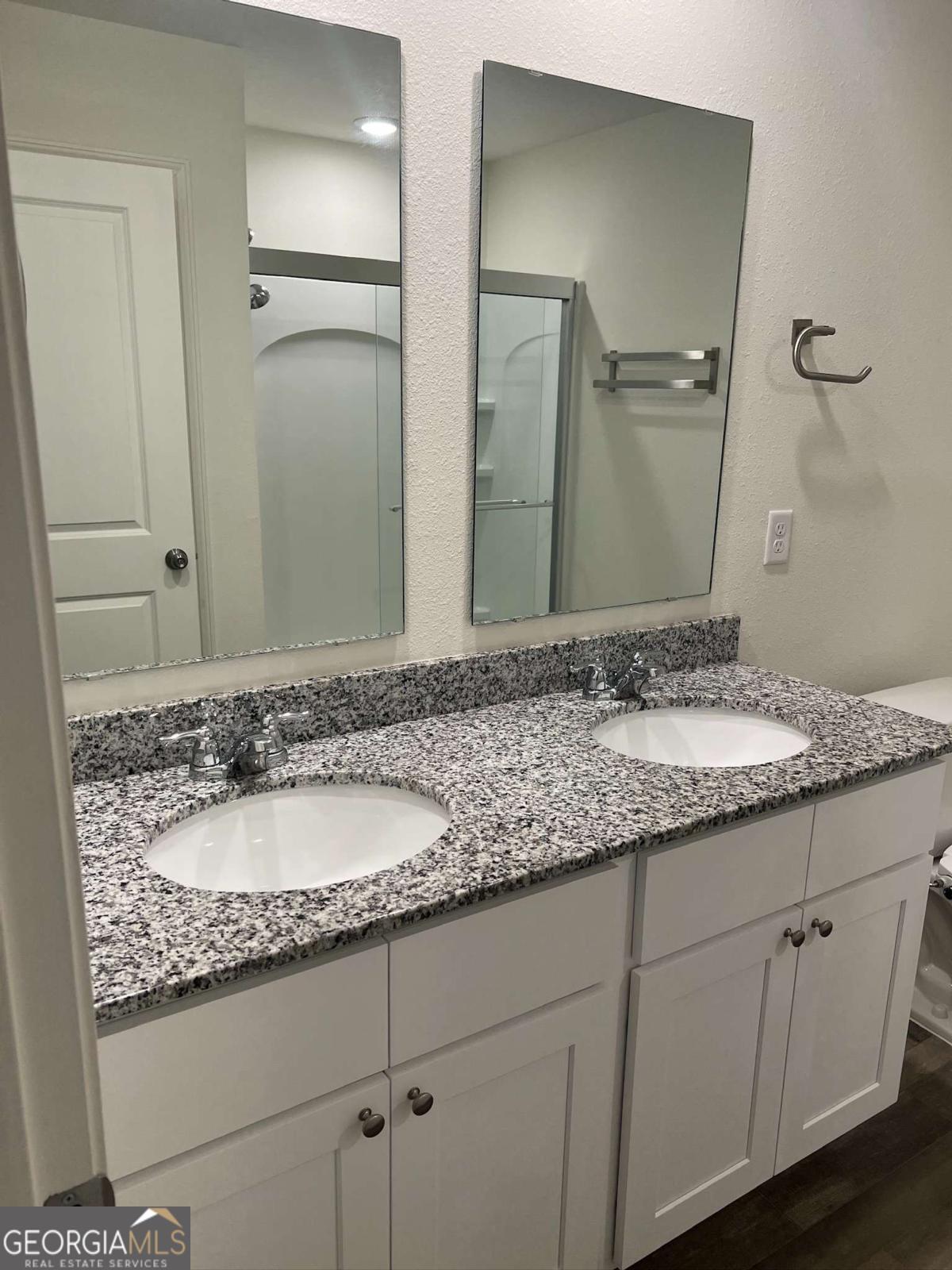 127 Oarsman Crossing St. Marys, GA 31558 - Photo 15 of 17 a bathroom with a granite countertop sink and a mirror