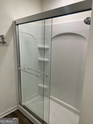 a bathroom with a glass shower door