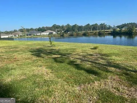 a view of a lake with houses in the background