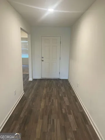a view of a room with wooden floor