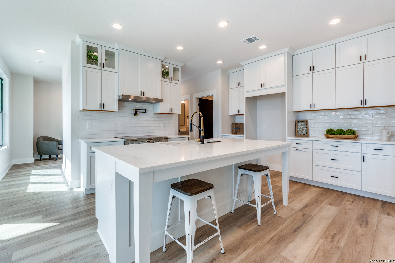 166 Restless Wind Spring Branch, TX 78070 - Photo 13 of 36 a kitchen with white cabinets and chairs