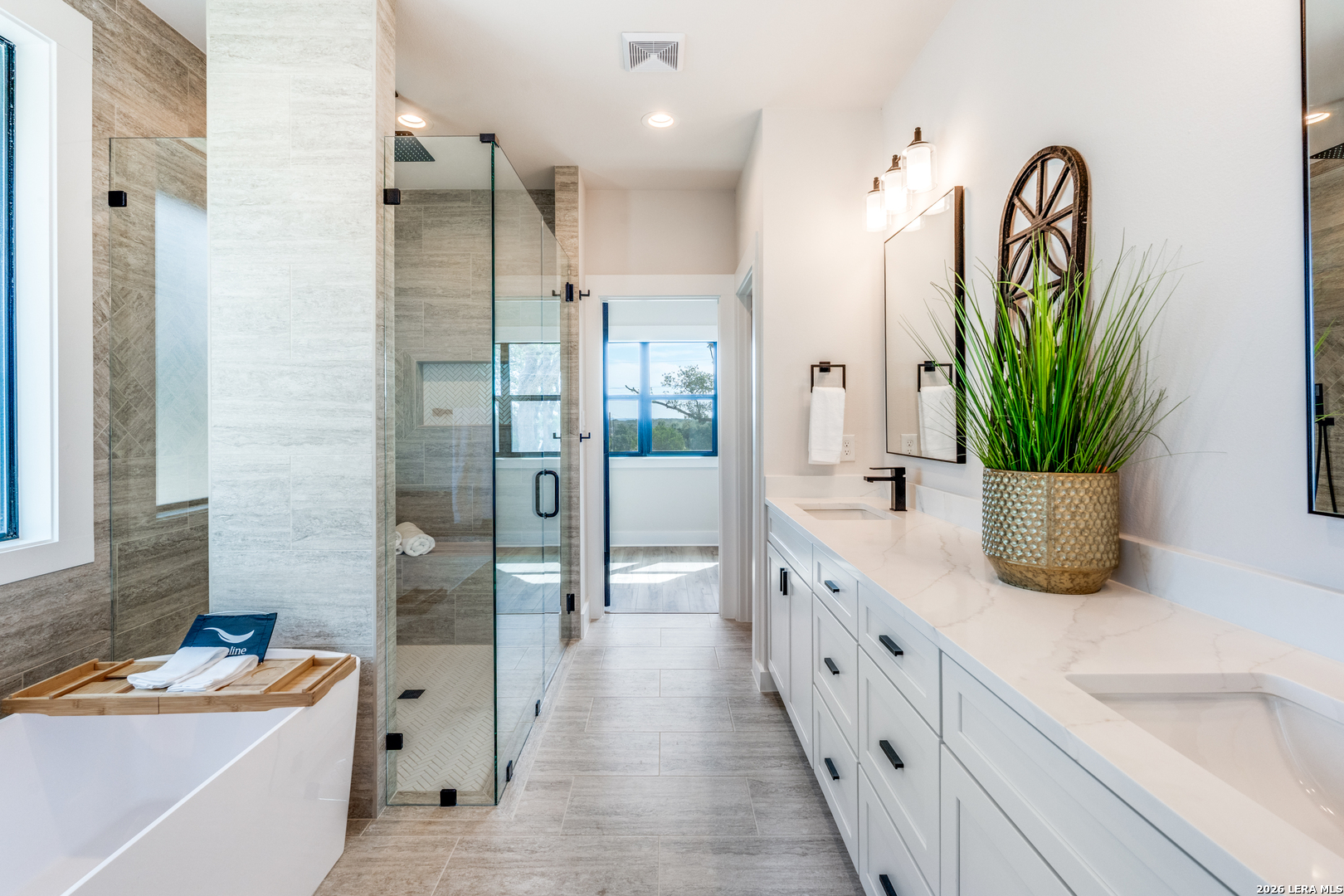 166 Restless Wind Spring Branch, TX 78070 - Photo 17 of 36 a bathroom with a tub sink and mirror