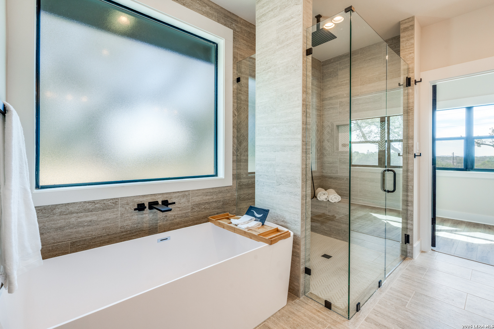 166 Restless Wind Spring Branch, TX 78070 - Photo 18 of 36 a bathroom with a tub a sink and mirror