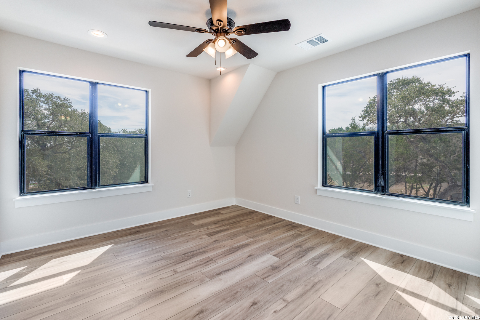 166 Restless Wind Spring Branch, TX 78070 - Photo 22 of 36 a view of an empty room with a window and wooden floor