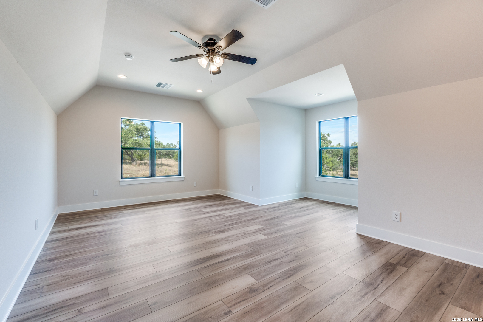 166 Restless Wind Spring Branch, TX 78070 - Photo 25 of 36 an empty room with wooden floor and windows