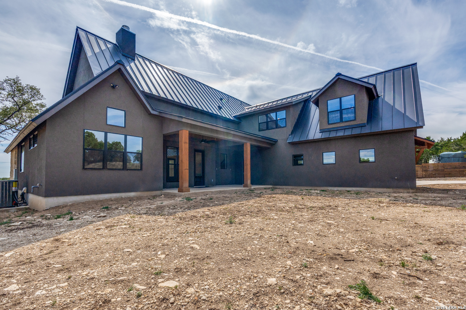 166 Restless Wind Spring Branch, TX 78070 - Photo 34 of 36 a front view of a house with a yard and garage