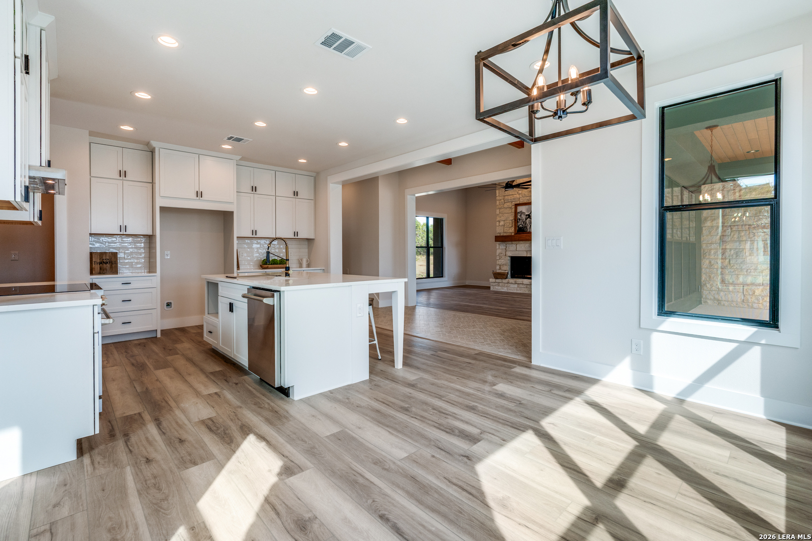 166 Restless Wind Spring Branch, TX 78070 - Photo 10 of 36 a kitchen with stainless steel appliances kitchen island granite countertop a refrigerator and a sink