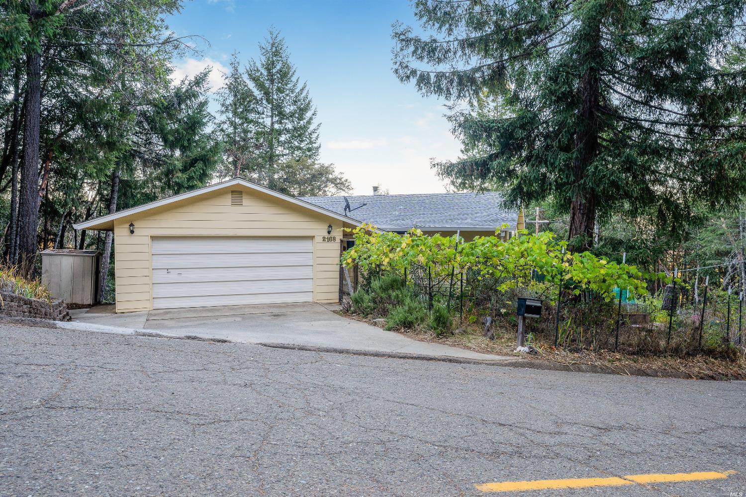 2168 Buckeye Road Willits, CA 95490 - Photo 1 of 1 a backyard of a house with plants and trees
