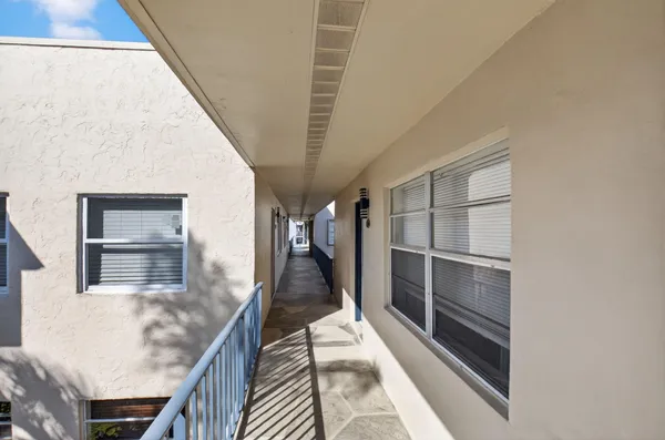 a living room with furniture a flat screen tv and a window