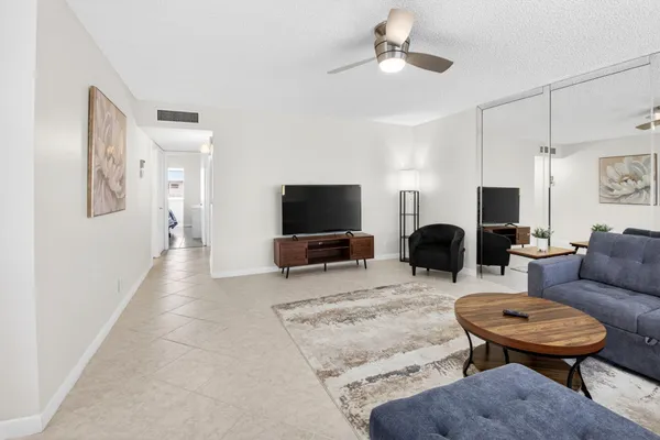 a view of a dining room with furniture and a window