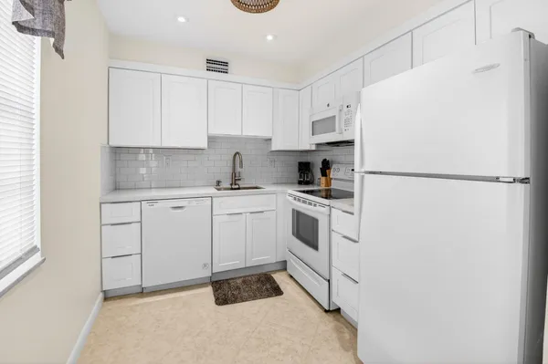 a bathroom with a sink a toilet a mirror and shower