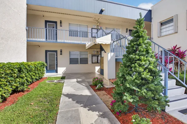 a view of a house with a yard and plants