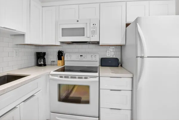 a bathroom with a granite countertop toilet sink and mirror