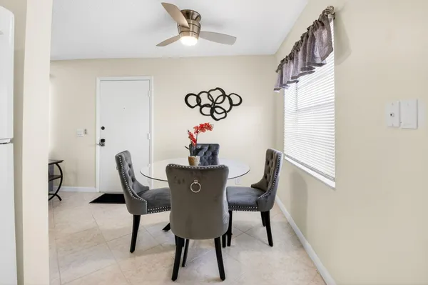 a bathroom with a granite countertop toilet a sink and a mirror